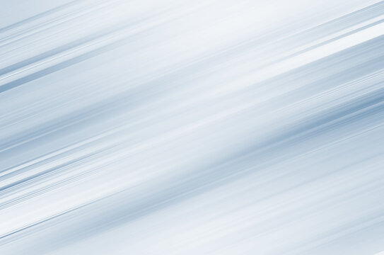 Blurred diagonal lines on a light blue background. Simple background for design and internet.