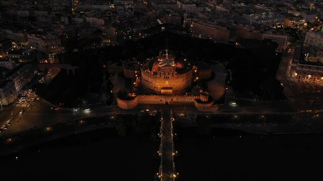 Aerial drone night video of Castel Sant'Angelo (castle of Holy Angel) as seen at dusk, Rome, Italy