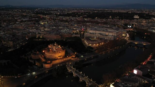 Aerial drone night video of Castel Sant'Angelo (castle of Holy Angel) as seen at dusk, Rome, Italy