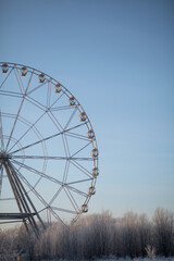 Fototapeta premium Ferris wheel in winter against the blue sky.