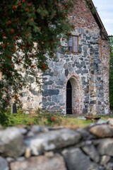 Medieval stone building and granite wall on the front.