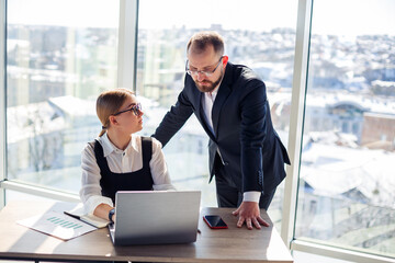 A female manager in her own office talks about a successful new business plan for economic...