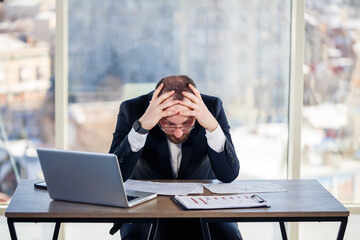 Adult male businessman, teacher, mentor is working on a new project in the office and is nervous....
