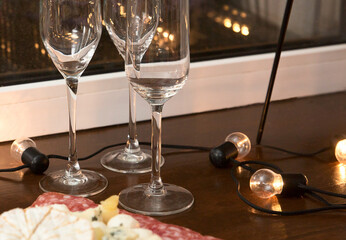 .Wine glasses on bokeh background. Christmas mood concept. Preparing for the holiday Close-up. Selective focus.