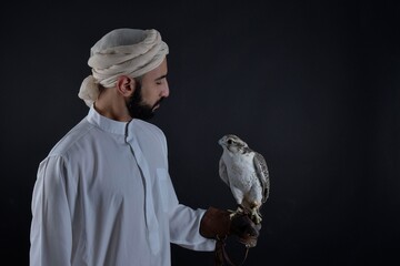Young falconer holding a bird of prey.