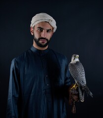 Young falconer holding a bird of prey.