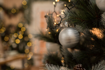 Christmas tree, christmas tree decorations and background with defocused lights, silver ball on christmas tree