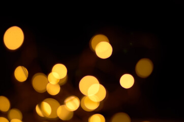Fototapeta premium golden defocused lights on a black background