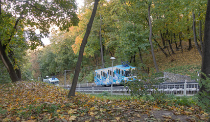 Fototapeta na wymiar Two cable cars in the autumn park