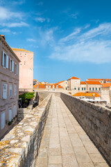 Fototapeta na wymiar Ancient stone wall of Dubrovnik Old Town, stunning fortification system. The world famous and most visited historic city of Croatia, UNESCO World Heritage site