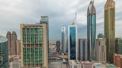 Panorama showing Dubai international financial center skyscrapers with promenade on a gate avenue aerial timelapse.