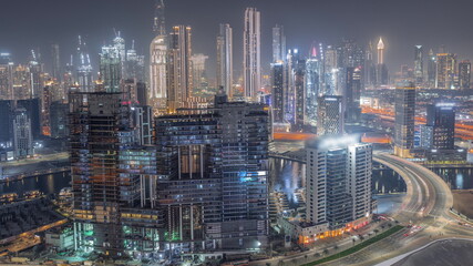Obraz na płótnie Canvas Panoramic skyline of Dubai with business bay and downtown district night timelapse.