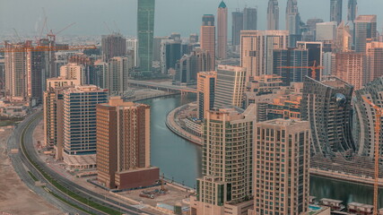 Fototapeta na wymiar Skyline with modern architecture of Dubai business bay towers morning timelapse. Aerial view