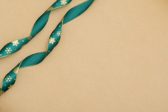 Green packing tape with a snowy pattern on a parchment background. New Year. For gifts. Abstract background. - Powered by Adobe