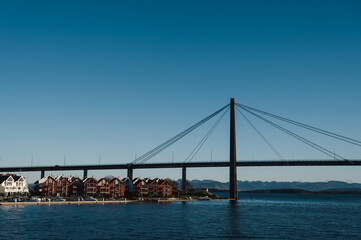 Scenic cityscape of modern norwegian town. Modern architecture of Stavanger. Sunny day. Huge bridge over fjord.