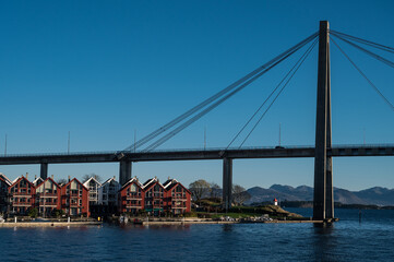 Scenic cityscape of modern norwegian town. Modern architecture of Stavanger. Sunny day. Huge bridge over fjord.