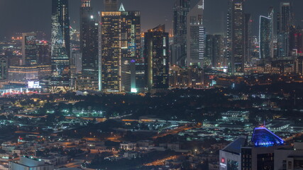 Rows of skyscrapers in financial district of Dubai aerial night timelapse.
