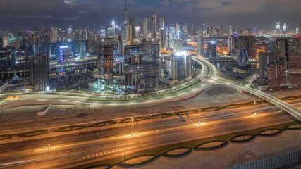 Fototapeta na wymiar Panoramic skyline of Dubai with business bay and downtown district night to day timelapse.