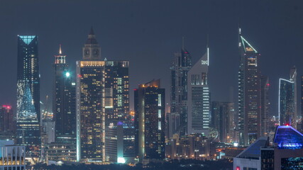 Rows of skyscrapers in financial district of Dubai aerial all night timelapse.