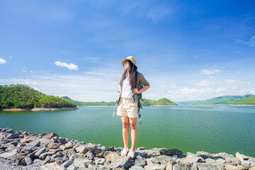 Young woman backpacking traveling front view