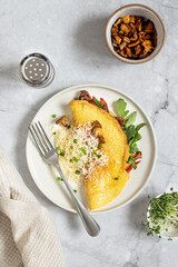 egg omelet with chanterelles, arugula and cheese for breakfast