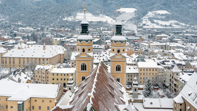 Cathedral of Santa Maria Assunta and San Cassiano in Bressanone. Brixen, is a little town in South Tirol in northern Italy. Aerial view of the old center city covered with snow in winter time.