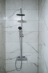 Shower in a marble booth. Shower system without a spill in a modern house. Contrast shower. Water...