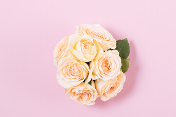 Roses bouquet top view on pink background