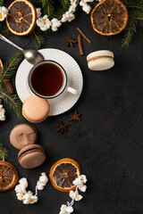 Obraz na płótnie Canvas Tea cup with macarons in Christmas decorations