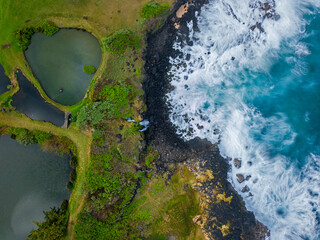 Aerial long exposure view of waves crashing on the south coast of Mauritius island