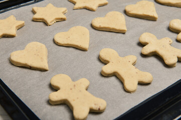 Close-up of laid out gingerbread cookies on a pastry rack. Cooking process. Christmas preparations. 25 December,