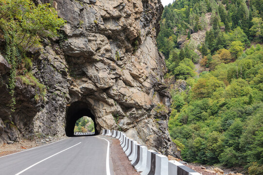 Scenic view of the tunnel in the rock on the mountain road