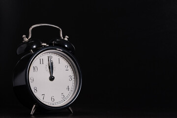 Naklejka premium 12 o'clock shown on old retro alarm clock. For topics like climate change, deadlines, new years eve, ... lot of copy space.