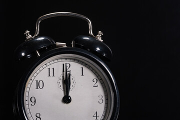 12 o'clock shown on old retro alarm clock. For topics like climate change, deadlines, new years eve, ... lot of copy space.