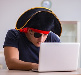 Digital security concept with pirate at computer