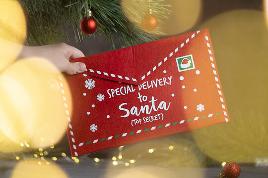 Red mail envelope for Christmas letters. Christmas and New Year's traditions of ordering gifts by mail from Santa.