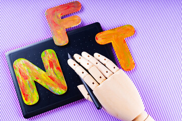 NFT Non-Fungible token . Artificial hand creates crypto art using a graphics tablet. Gypsum copy of...