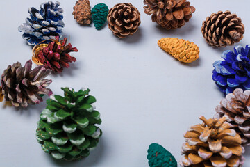 Eco friendly Christmas, New Year decorations, multicolored painted natural pine, fir cones, no plastic concept. Copy space.