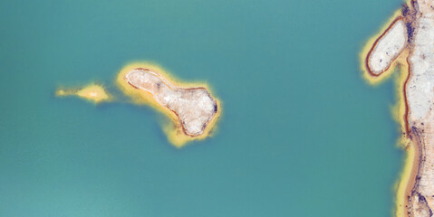 Quarry for mining and enrichment of titanium and other rare ores. Blue water in the enrichment tank.