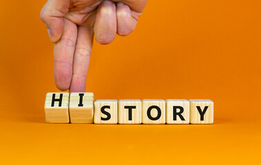 Story and history symbol. Historic turns a cube, changes the word story to history. Beautiful orange table, orange background. Business, historical and story or history concept. Copy space.