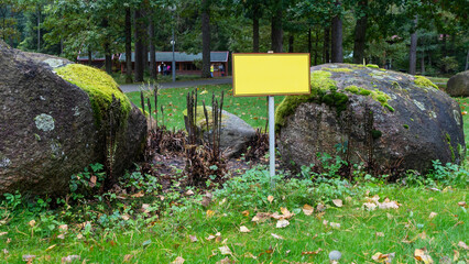 Empty sign board on grass with space for caption. Notice board with copyspace for prohibition.