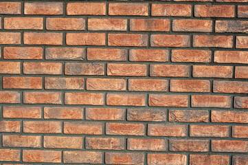 red old brick wall background, brick wall texture, structure. old broken brick, cement joints, close-up.