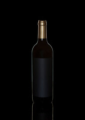 bottle of red wine on black background with reflection