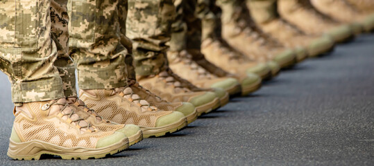 The soldiers' legs are dressed in ankle boots and camouflage pants.