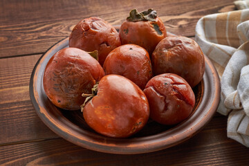 ugly fruits persimmon on brown background ugly food zero waste