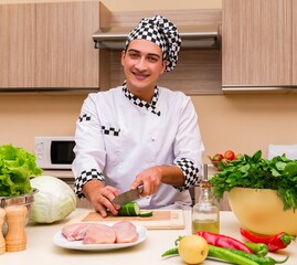 Young chef working in the kitchen