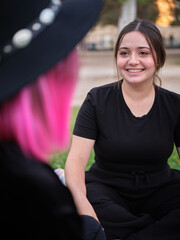 woman sitting smiling and looking at her friend