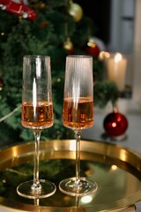 Selective focus glasses of champagne near the new year tree in the new year 2022