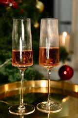 Selective focus glasses of champagne near the new year tree in the new year 2022