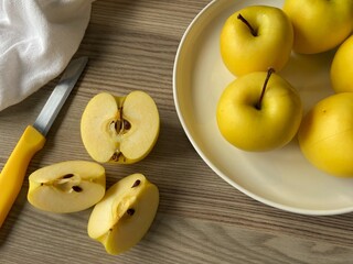 Yellow apples, golden yellow apples in a white plate. 